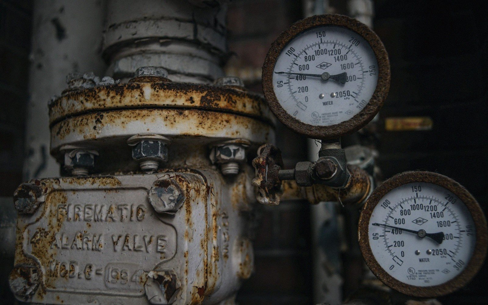 a ship's boiler room with pipework and gauges