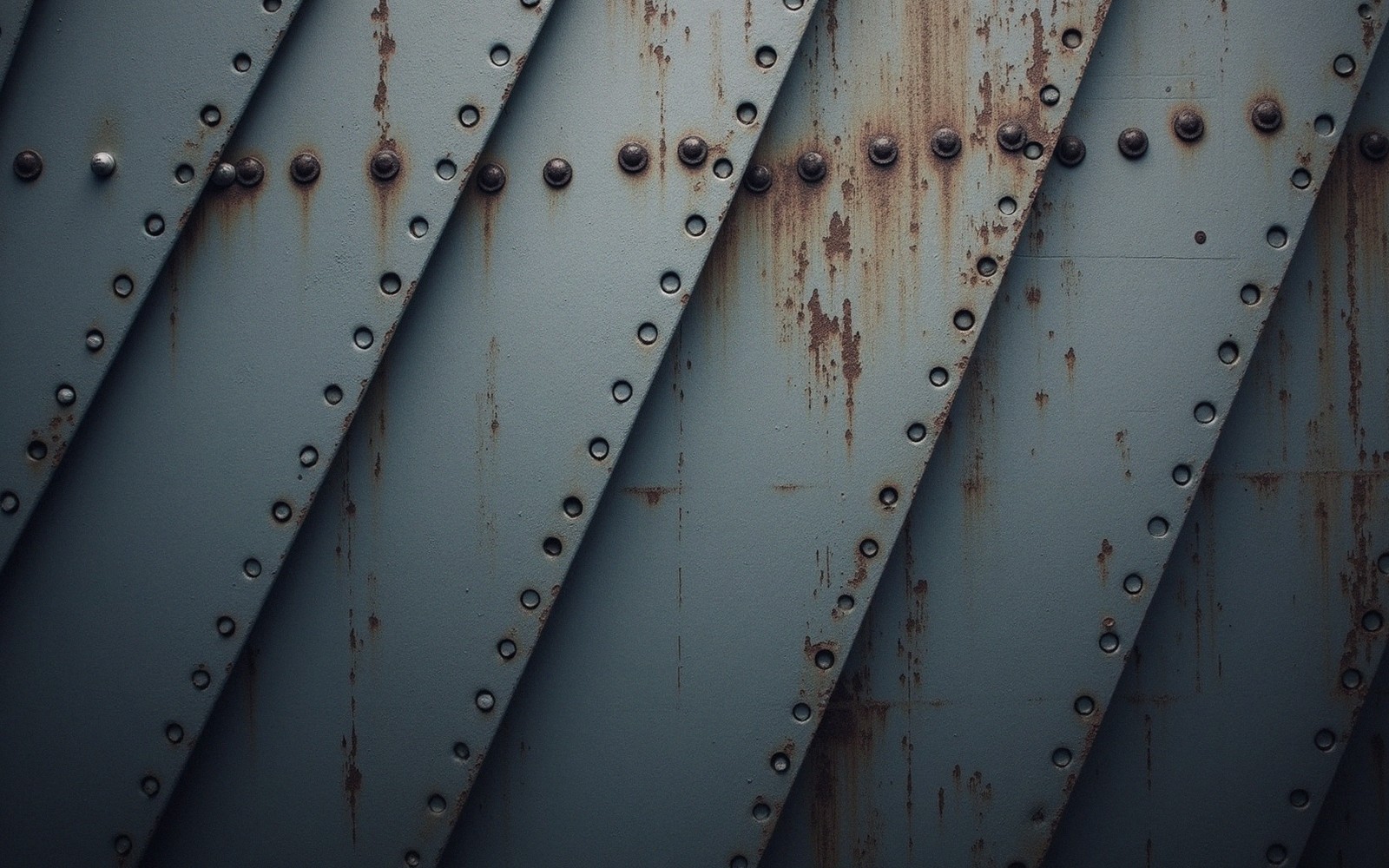 a riveted steel hull plate close up with overlapping seams